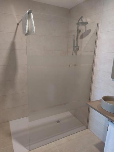 a shower with a glass door in a bathroom at Apartamento Nuevo Ondina in Begur