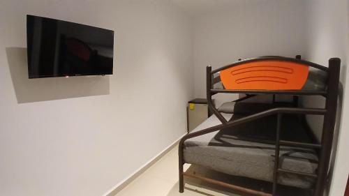 a room with a chair and a flat screen tv at Villa Leo in Cancún