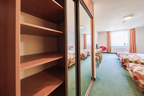 a room with two beds and a mirror at Hotel Sobieszewo in Gdańsk