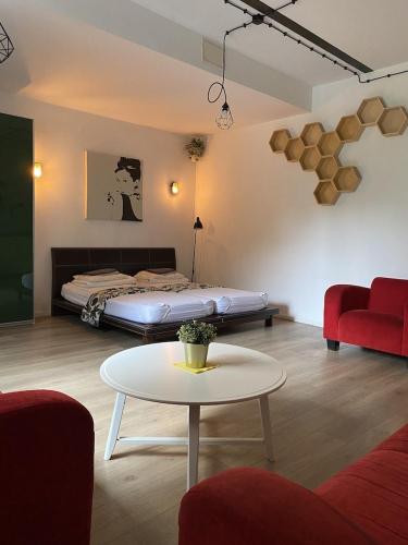 a living room with a bed and a coffee table at SPOKO Hostel in Gdańsk