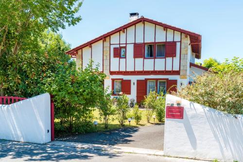 a house with a fence in front of it at Les Chambres D'arrauntz - Ibaia in Ustaritz