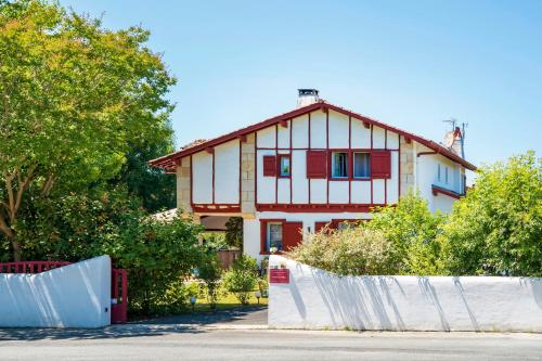 a house with a fence in front of it at Les Chambres D'arrauntz - Ibaia in Ustaritz