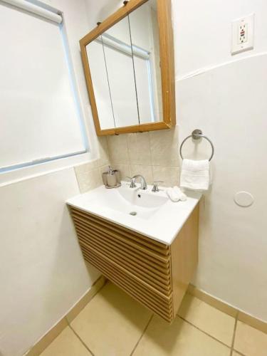 a bathroom with a sink and a mirror at Relaxed and Cozy Poolside Studio - LOU2 - BUR in Burbank