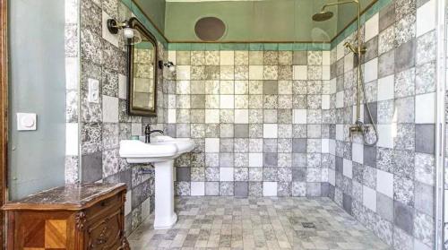 a bathroom with a sink and a mirror at French Manor House with private gardens and pool in Foissac