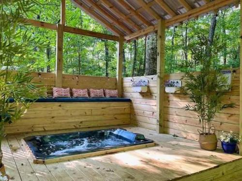 a hot tub in the middle of a wooden house at Falcon Lodge - hot tub fire pit & games in Mentone