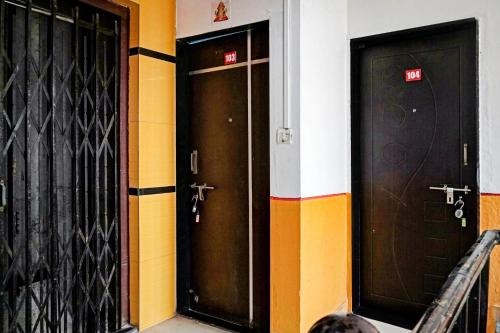 two doors on the side of a building at Hotel O Way Point in Méribel Village