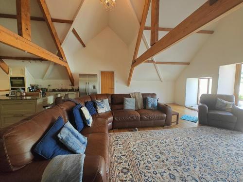 a large living room with a brown leather couch at 6 Bed in Blaencwm oc-t32688 in Blaencwm