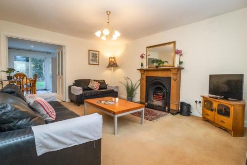a living room with a couch a table and a fireplace at Aughrim Holiday Village No 6 by Trident Holiday Homes in Aughrim