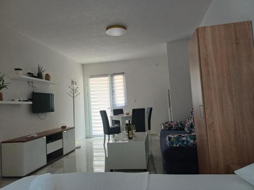 a living room with a bed and a table and chairs at Apartment Brijest-Kotor in Kotor