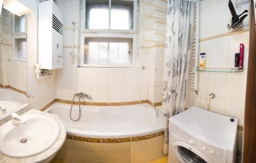 a bathroom with a tub and a sink and a toilet at Apartment Ve Smeckach with a big Terrace in Prague