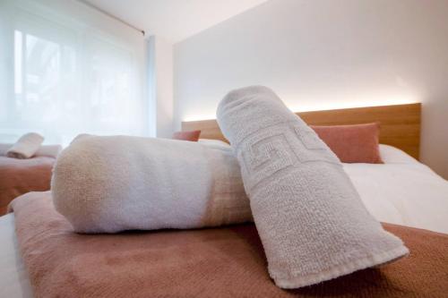 a white sock sitting on top of a bed at Suances Brisa Del Cantábrico in Suances