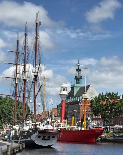 two boats are docked in the water in a harbor at Hotel DH -Deutsches Haus- in Emden
