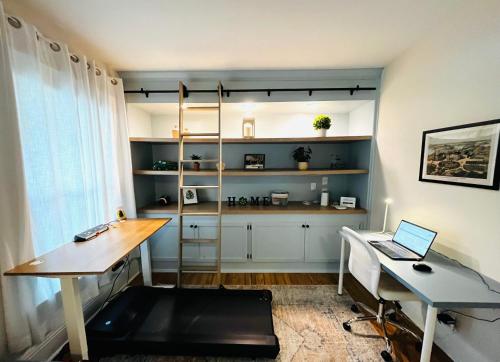 a room with a desk and a laptop on a table at Sweet Retreat 3 Mins to Notre Dame Eddy St Commons and Memorial Hospital in South Bend