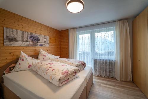 a bedroom with a bed and a large window at Gästehaus Höck in Tschagguns