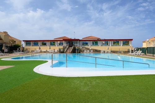 a large swimming pool in front of a building at Bungalow with Terrace BBQ Pool in Maspalomas in Maspalomas