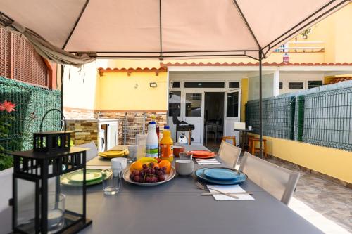 a table with a bowl of fruit on a patio at Bungalow with Terrace BBQ Pool in Maspalomas in Maspalomas