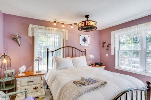 a bedroom with a large bed with pink walls at Lakefront and Dog-Friendly Gem in Gravois Mills in Gravois Mills