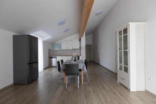 a kitchen and dining room with a table and chairs at Villa Andrea Apartments - Ljubljana in Ljubljana