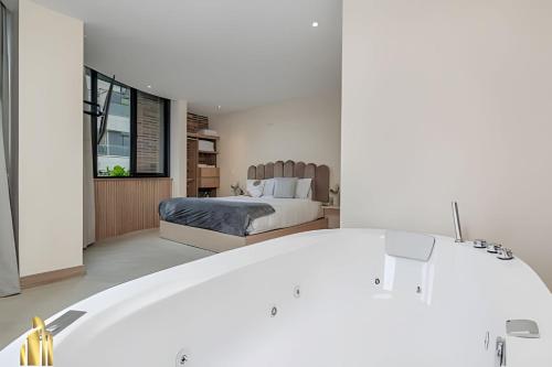 a bedroom with a bed in a room at Solei Loft 301 - Location/Trendy Jacuzzi Living in El Poblado