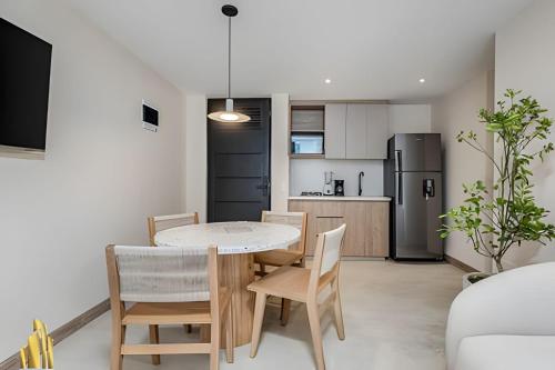 a kitchen and dining room with a table and chairs at Solei Loft 301 - Location/Trendy Jacuzzi Living in El Poblado
