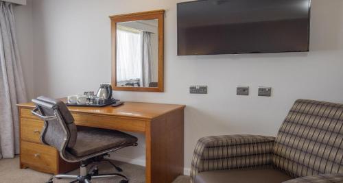 a room with a desk and a chair and a mirror at Invercarse Hotel Dundee, BW Signature Collection in Dundee