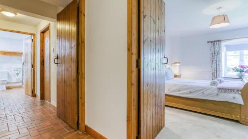 a bedroom with a bed and a window at Felin Hen in Menai Bridge