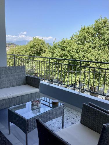 a patio with couches and tables and a balcony at Sea breeze in Nafpaktos