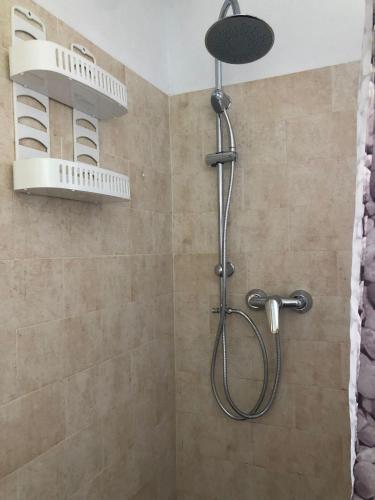a shower with a shower head in a bathroom at Finca Abril 1 Piscina Compartida in Conil de la Frontera