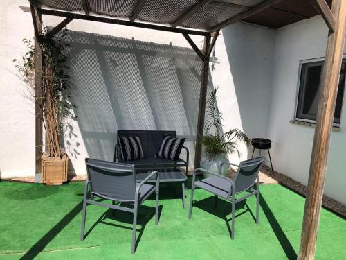a patio with chairs and a table and a table and chairs at Finca Abril 1 Piscina Compartida in Conil de la Frontera