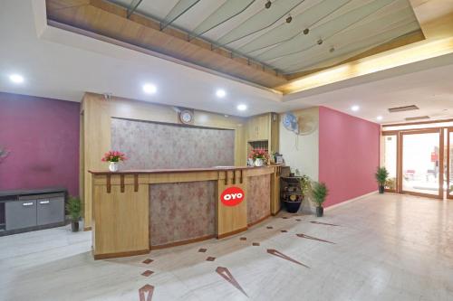 an office lobby with a reception desk and a large screen at Hotel O Padmini Near Lakdikapool Metro Station in Hyderabad