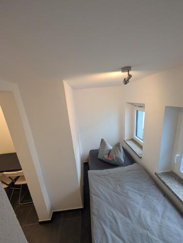 a small room with a bed and a window at Meisterhaus Appartment 9 in Glauchau