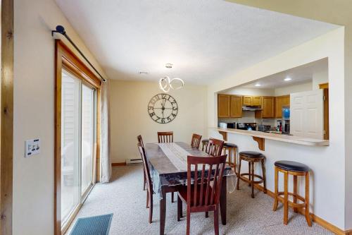 a kitchen and dining room with a table and chairs at Northridge 181 in Tannersville