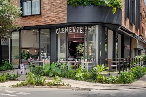 a store front of a restaurant with tables and plants at Solei Loft 201 - Luxe Stay in El Poblado in El Poblado