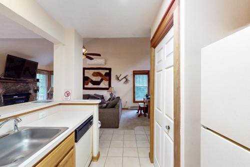 a kitchen with a sink and a living room at Northridge 472 in Tannersville