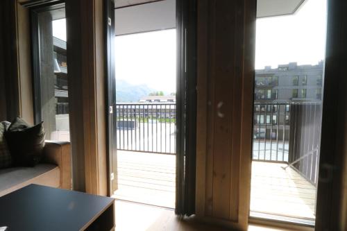 a room with a door open to a balcony at Stylish apartment in Hemsedal, Ski in-ski out in Hemsedal