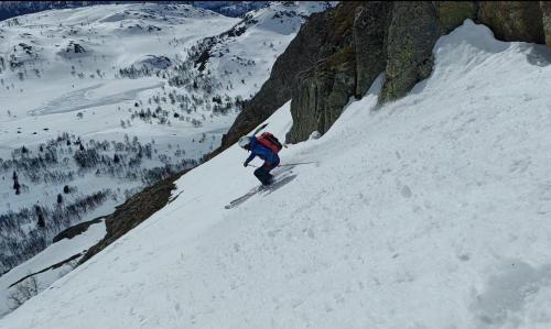 a person is skiing down a snow covered mountain at Stylish apartment in Hemsedal, Ski in-ski out in Hemsedal