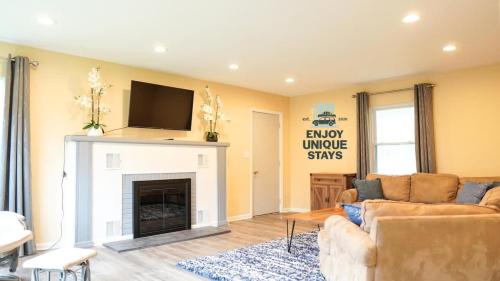 a living room with a couch and a fireplace at Fisher's Fancy l Near the river & in house games in Berrien Springs