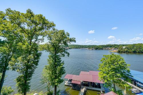 arial view of a lake with a house and trees at Hot Tub and Dock Lake Ozark Vacation Home! in Lake Ozark