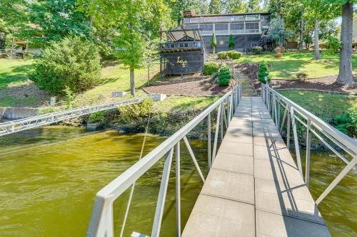a walkway over a river with a bridge at Hot Tub and Dock Lake Ozark Vacation Home! in Lake Ozark