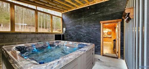 a large hot tub in a room in a house at Southern Comfort Retreat with a private hot tub in Scottsboro