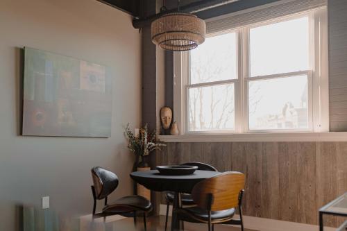a dining room with a table and chairs and a window at Modern Industrial Loft for Two in Benton Harbor