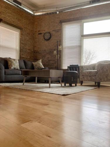 a living room with a couch and a coffee table at Romantic Gastro Loft Retreat for Two in Benton Harbor