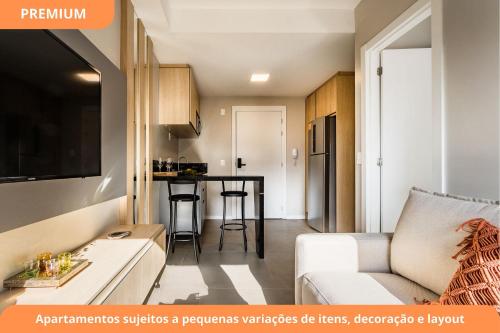 a small apartment with a kitchen and a living room at GO Carlos Gomes by My Way in Porto Alegre