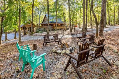 a group of chairs sitting around a campfire in the woods at Canopy Woods - 2 beautiful homes with a hot tub in Mentone
