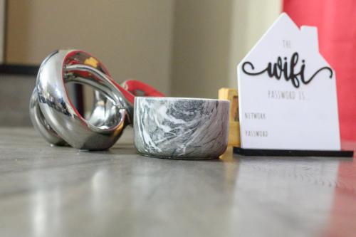 a pair of scissors and a cup on a table at Chateau Central at Sunbury Apts in Kingston
