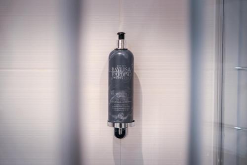 a bottle of alcohol hanging on a wall at Coach & Horses Hotel in Cardiff
