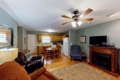 a living room with a couch and a ceiling fan at Scenic Solitude at Cabins in the Clouds in Rising Fawn
