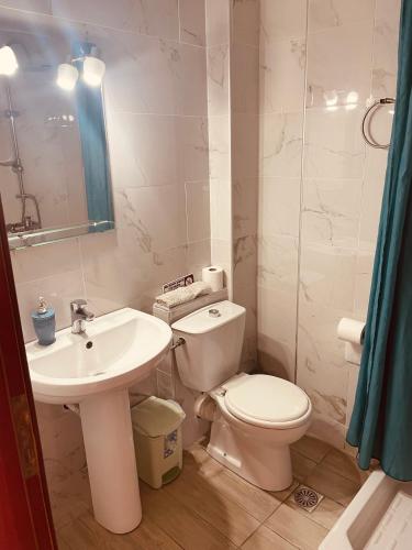 a bathroom with a toilet and a sink at Babos Holidays in Ammoudia