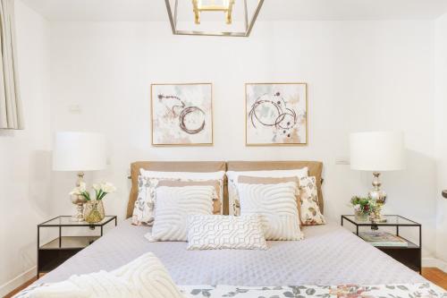a bedroom with a bed with pillows and two tables at The Secret Escape Villa in Sant' Alessio