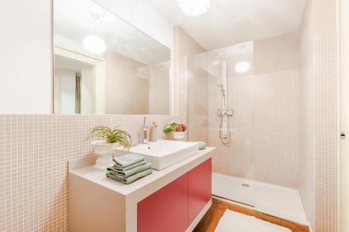 a bathroom with a white sink and a tub at The Secret Escape Villa in Sant' Alessio